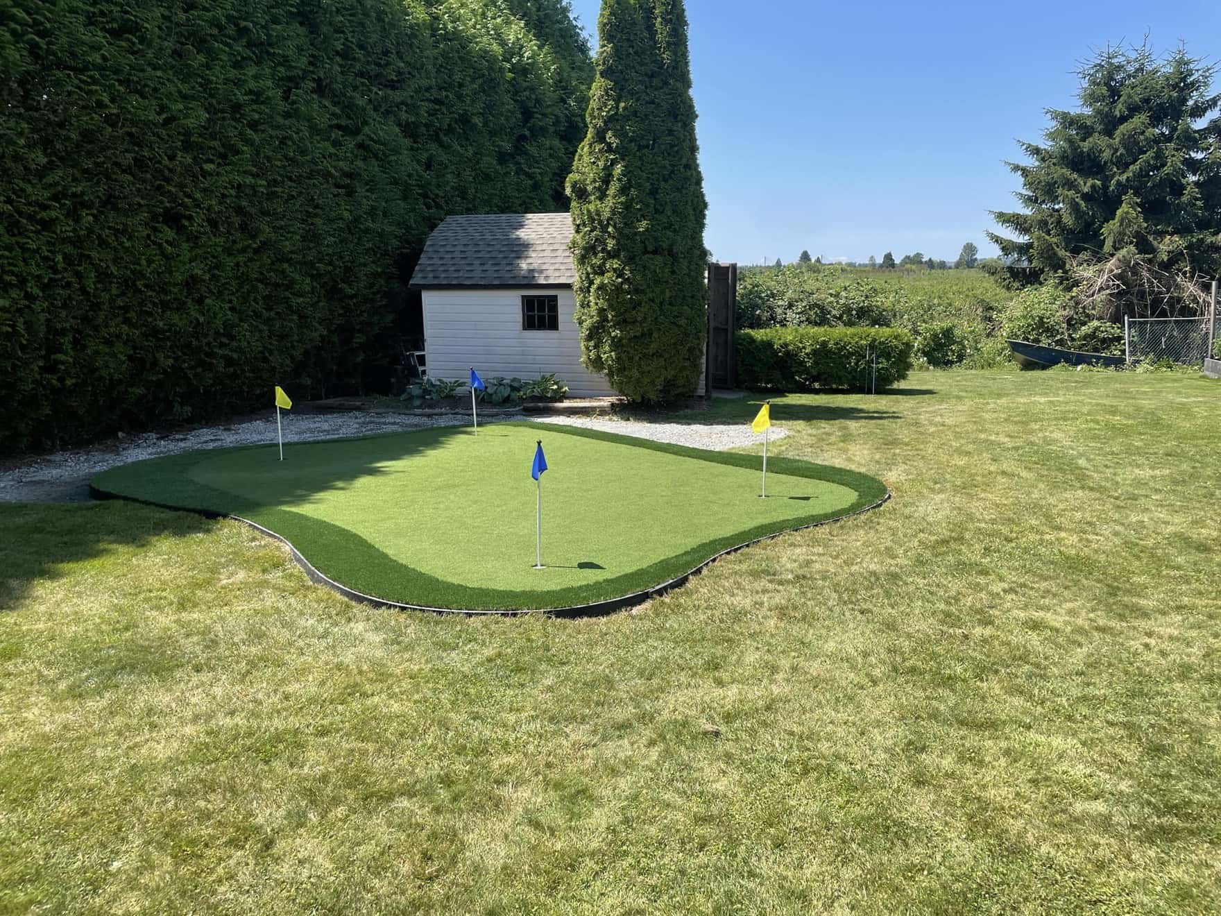 artificial turf putting green installed in a backyard