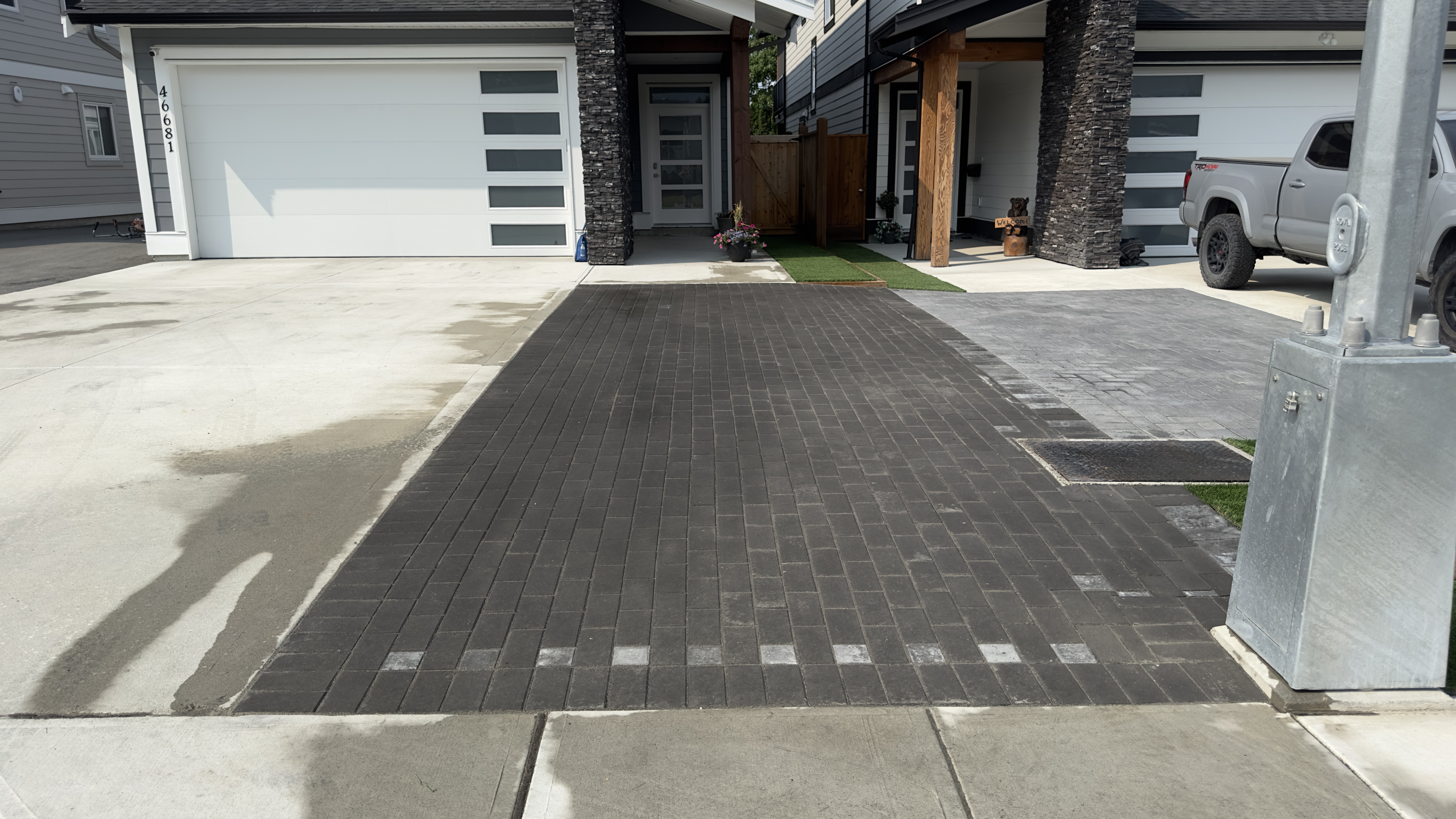 a front driveway with a clean aesthetic done with pavers