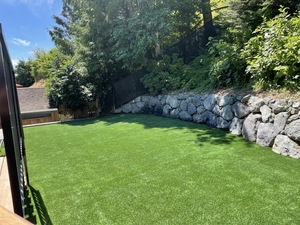 professional artificial turf installation in a backyard